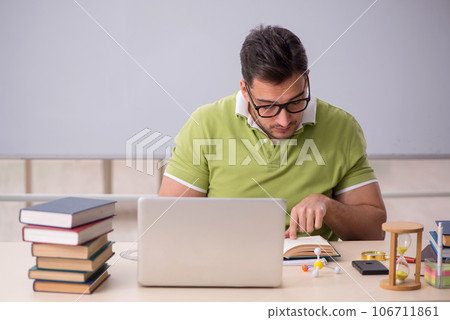 Young male student preparing for exams in the classroom Young male student preparing for exams in the classroom 106711861