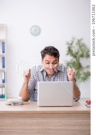 Young male employee working in the office Young male employee working in the office 106711862