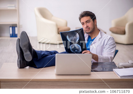 Young doctor radiologist sitting at the hospital 106711870