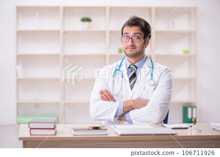 Young male doctor working in the clinic Young male doctor working in the clinic 106711926