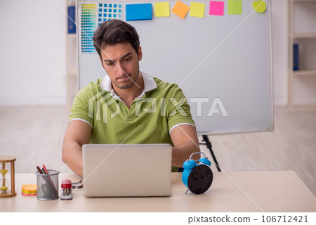 Young male designer sitting in the office Young male designer sitting in the office 106712421