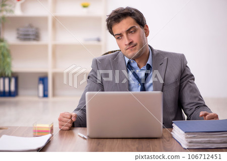 Young male employee working in the office 106712451