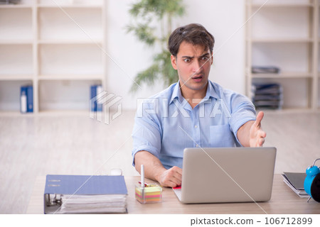 Young male employee working in the office 106712899