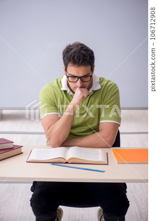 Young male student sitting in the classroom 106712908