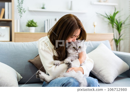 Portrait of young Asian woman holding cute cat Portrait of young Asian woman holding cute cat 106712980