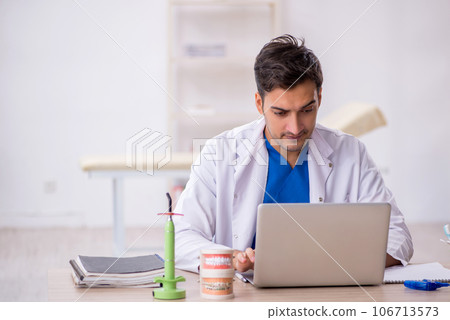 Young male dentist working in the clinic 106713573