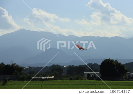 Summer landscape with bird chasing kite, rice fields, mountains, clouds and blue sky Summer landscape with bird chasing kite, rice fields, mountains, clouds and blue sky 106714337