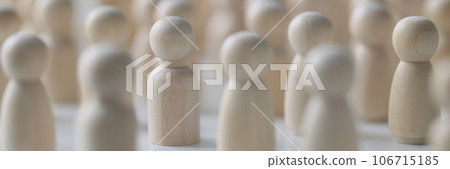Many wooden figures standing close to each other, shallow depth of field. 106715185