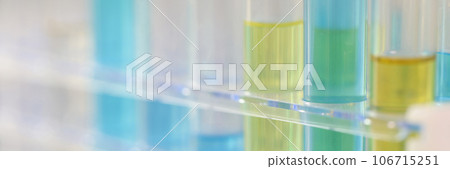Many test tubes with different chemical solutions in a row on laboratory table. 106715251