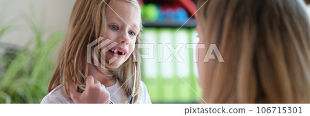 Family doctor plays with young patient in medical clinic. Family doctor plays with young patient in medical clinic. 106715301