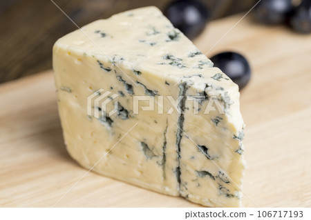Cheese with blue mold cut into pieces Cheese with blue mold cut into pieces 106717193