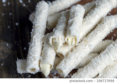 Waffle tubes with butter cream and coconut sprinkles 106717698