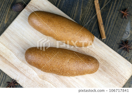 fresh wheat bread with bran on the cutting board 106717841