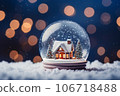 a house and white snow-covered trees on a snowy winter background in a small ball of glass. 106718488
