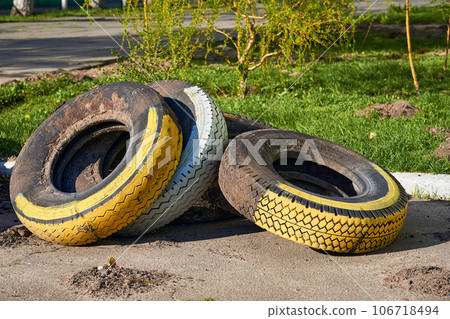 Old car tires used to create flower beds, street decor, fence Old car tires used to create flower beds, street decor, fence 106718494