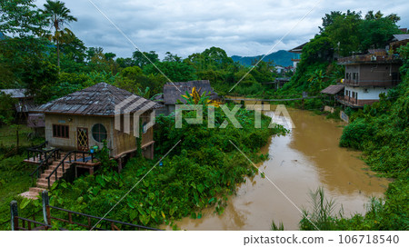 Village and mountain in Vang Vieng, Laos, Nam Song River in Vang Vieng, Laos. Village and mountain in Vang Vieng, Laos, Nam Song River in Vang Vieng, Laos. 106718540