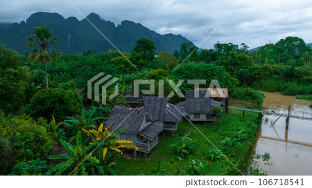 Village and mountain in Vang Vieng, Laos, Nam Song River in Vang Vieng, Laos. Village and mountain in Vang Vieng, Laos, Nam Song River in Vang Vieng, Laos. 106718541