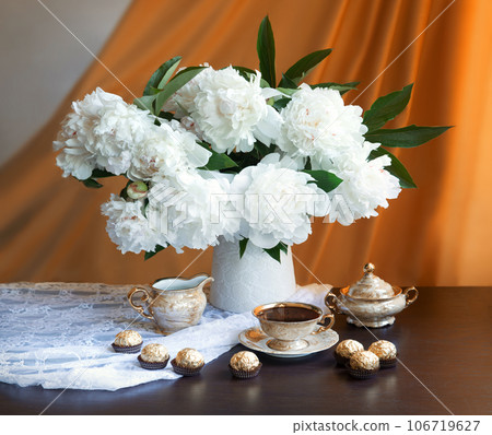 Still life. Coffee, sweets and a bouquet of peonies 106719627