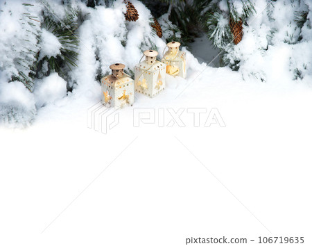 Lanterns in the snow under the Christmas tree 106719635