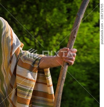 Man's hand with a wooden staff Man's hand with a wooden staff 106719705
