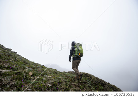 Successful woman hiker hiking at mountain top in tibet 106720532