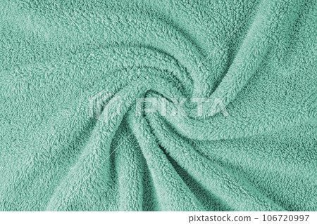 Terry cloth, turquoise towel texture background. Soft fluffy textile bath or beach towel material Terry cloth, turquoise towel texture background. Soft fluffy textile bath or beach towel material 106720997
