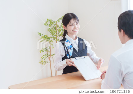 Reception staff explaining the contract 106721326