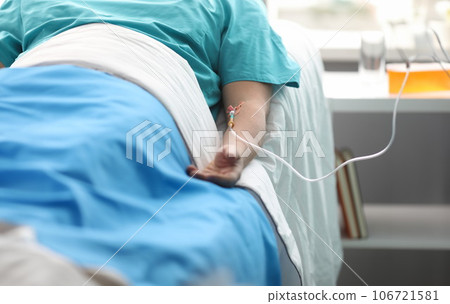 Hand of a young man with a dropper in ward of medical hospital 106721581
