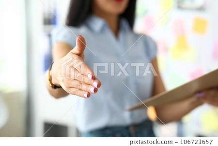 Smiling female manager giving hand to client 106721657