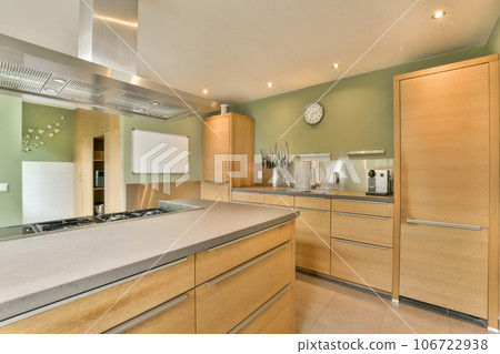 a modern kitchen with wood cabinets and stainless appliances on the counter tops in this photo is taken from the inside a modern kitchen with wood cabinets and stainless appliances on the counter tops in this photo is taken from the inside 106722938