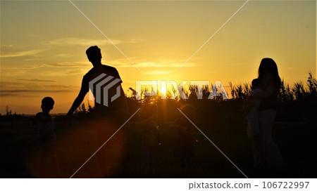 A family relaxing in the sunset. A family relaxing in the sunset. 106722997