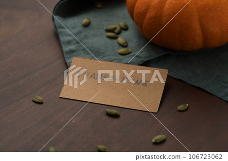 Orange pumpkin with seeds on wood table with thanksgiving paper card 106723062