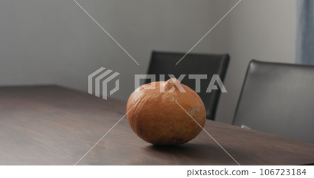 orange pumpkin on walnut table orange pumpkin on walnut table 106723184