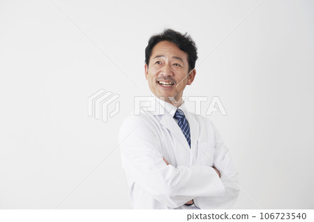 Portrait of a smiling middle-aged doctor, white background Portrait of a smiling middle-aged doctor, white background 106723540