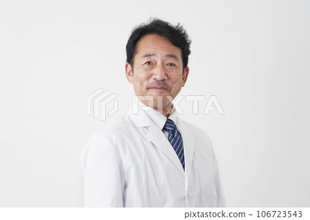 Portrait of a smiling middle-aged doctor, white background, looking at camera 106723543