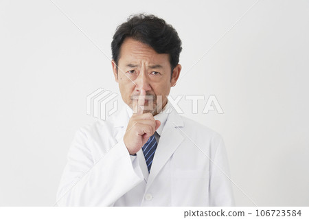 Middle-aged doctor posing in a secret pose, white background 106723584