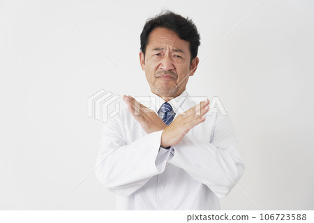 Middle-aged doctor making a mark with his arm, white background Middle-aged doctor making a mark with his arm, white background 106723588