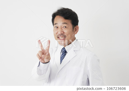 Middle-aged doctor giving a peace sign, white background 106723606