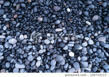 Gray pebbles as a background. Round stones on the beach. Photography for design. 106724213
