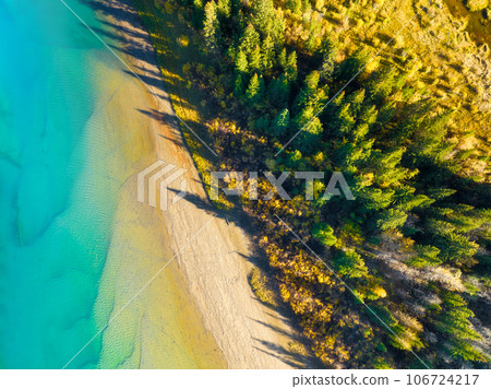 Fall time. A drone view of the river in the woods. An aerial view of an autumn forest. Fall time. A drone view of the river in the woods. An aerial view of an autumn forest. 106724217