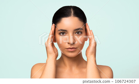 Glamorous natural beauty headshot portrait of a beautiful multiracial Turkish woman with perfect moisturized healthy skin and charming smile naked shoulders Glamorous natural beauty headshot portrait of a beautiful multiracial Turkish woman with perfect moisturized healthy skin and charming smile naked shoulders 106724307