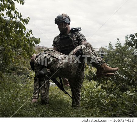 The commander carries a wounded soldier 106724438
