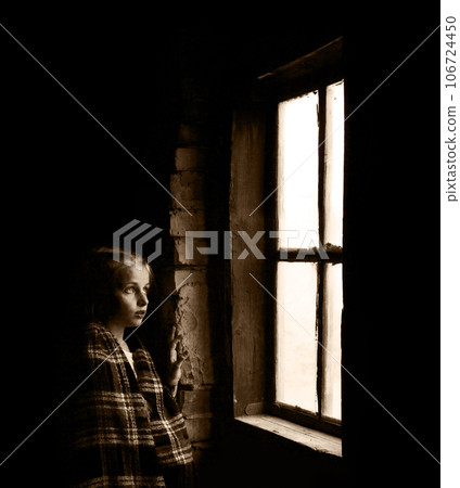 Girl at the window on a black background Girl at the window on a black background 106724450