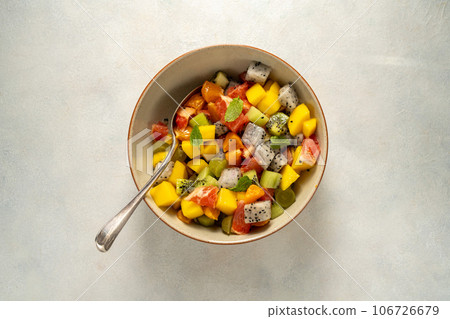 Exotic fruit salad with fresh mango, dragon fruit, grapefruit, kiwi. Exotic fruit salad with fresh mango, dragon fruit, grapefruit, kiwi. 106726679