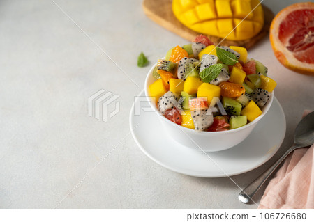 Exotic fruit salad with fresh mango, dragon fruit, grapefruit, kiwi. Copy space Exotic fruit salad with fresh mango, dragon fruit, grapefruit, kiwi. Copy space 106726680