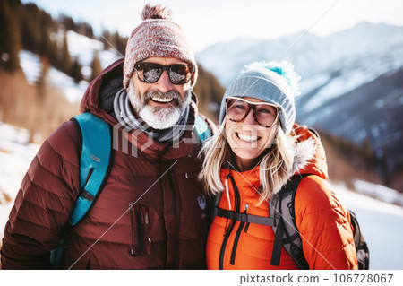 Family happy age couple or friends in winter clothes on the background of snowy mountains Family happy age couple or friends in winter clothes on the background of snowy mountains 106728067