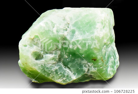 Jadeite is rare precious natural geological stone on gradient background in low key, isolate. 106728225