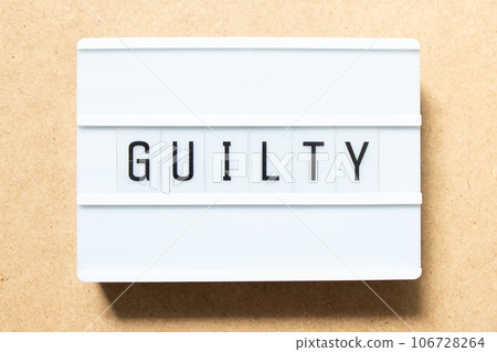 Lightbox with word guilty on wood background Lightbox with word guilty on wood background 106728264
