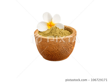 Henna powder in coconut bowl with frangipani flower isolated on white 106729171