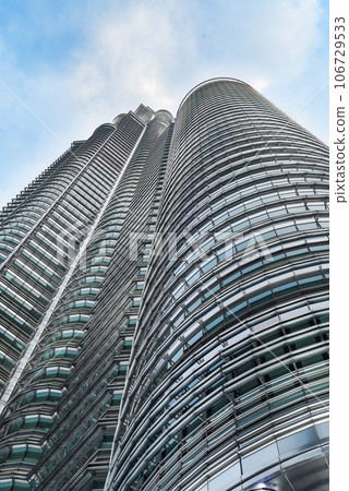 Kuala Lumpur, Malaysia - 26 August 2023: Petronas twins tower from close up point of view Kuala Lumpur, Malaysia - 26 August 2023: Petronas twins tower from close up point of view 106729533